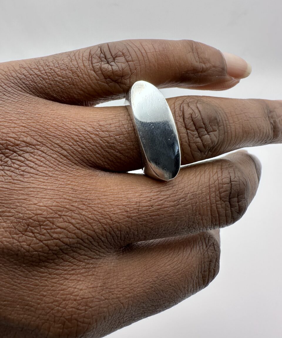 andcrafted minimalist silver geometric ring on white background