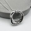 Hand molten silver organic pendant necklace on silver ball chain, textured and hallmarked artisan jewellery.