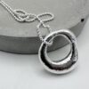 Handcrafter molten silver organc pendant necklace on a silver ball chain, textured and hallmarked artisan jewellery.
