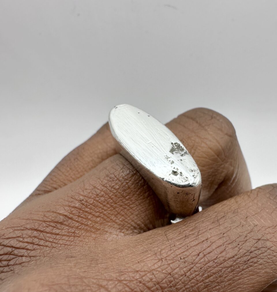 handmade sterling silver raw edge signet ring with molten textured surface
