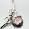 Handmade sterling silver bangle with rose quartz charm on wrist – artisan jewellery by Bohdee.