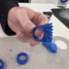 Person carving ring from wav using small hand tools during a jewellery workshop