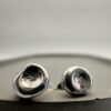 Bohdee tiny solid silver dimple stud earring with a textured recessed centre and polished rounded edge.