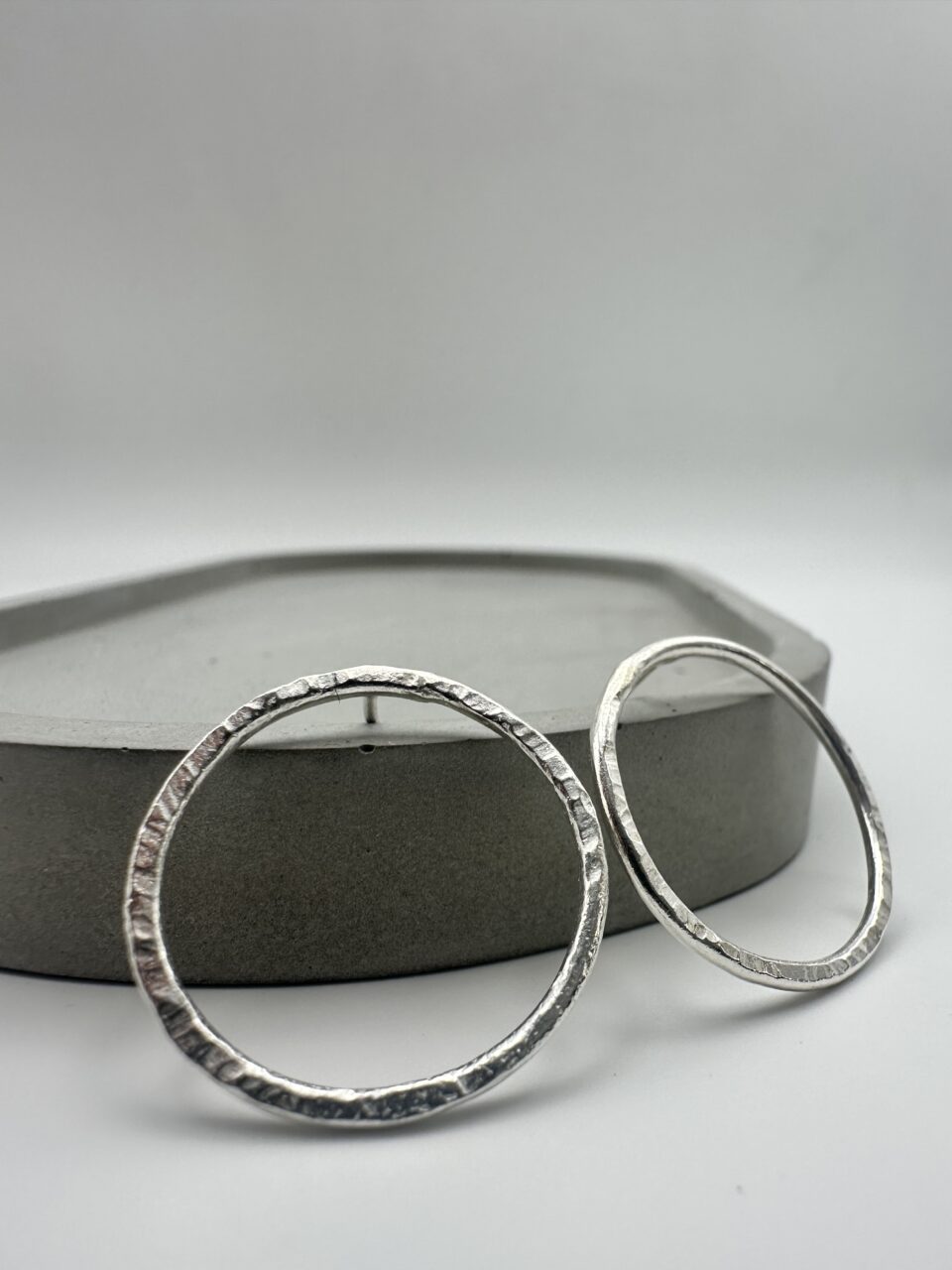 Bohdee recycled silver statement earrings with layered angular shapes, textured surfaces and irregular open centres.