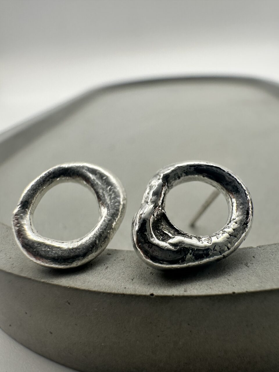 Bohdee small solid silver molten stud earrings with irregular open-circle shapes and softly textured surfaces.