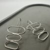 Bohdee recycled silver drop earrings with three stacked open oval shapes and long hook fittings.