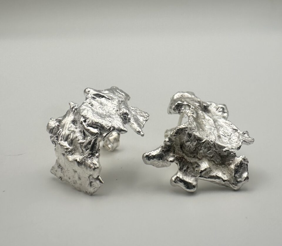 Bohdee recycled silver statement earrings with layered angular shapes, textured surfaces and irregular open centres.