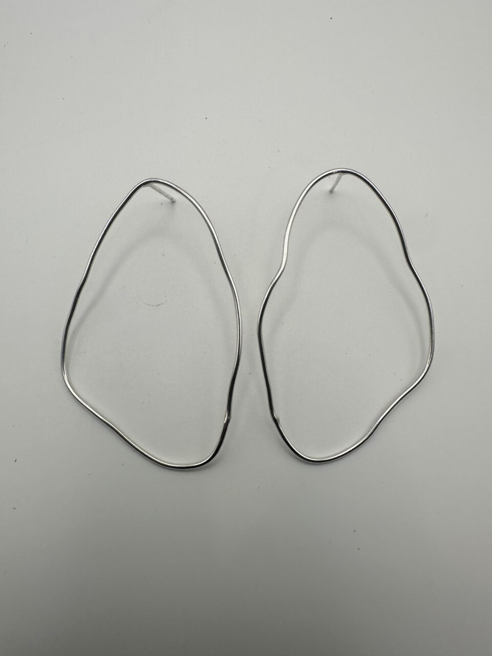 Bohdee large recycled silver organic stud earrings with flowing irregular outlines and a polished finish.