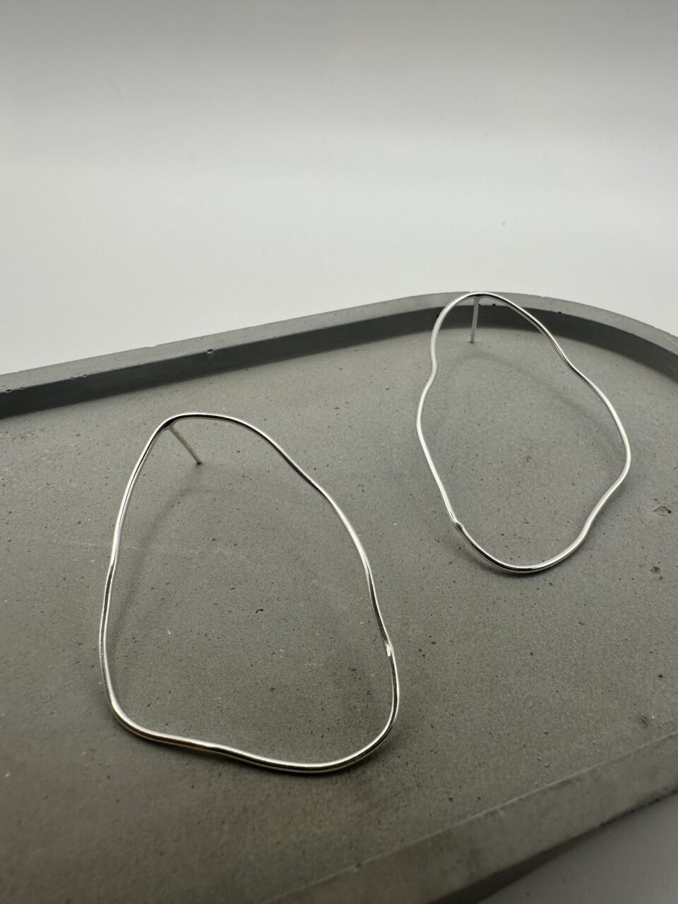 Bohdee large recycled silver organic stud earrings with flowing irregular outlines and a polished finish.
